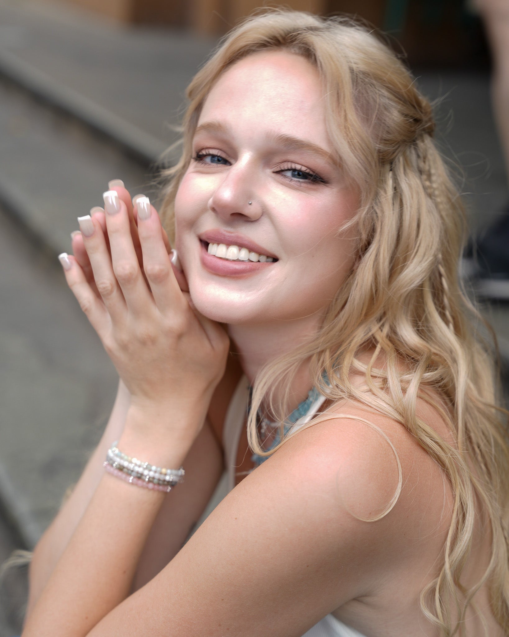 Smiling model wearing aquamarine and silver bracelets - handcrafted gemstone jewelry by elswre