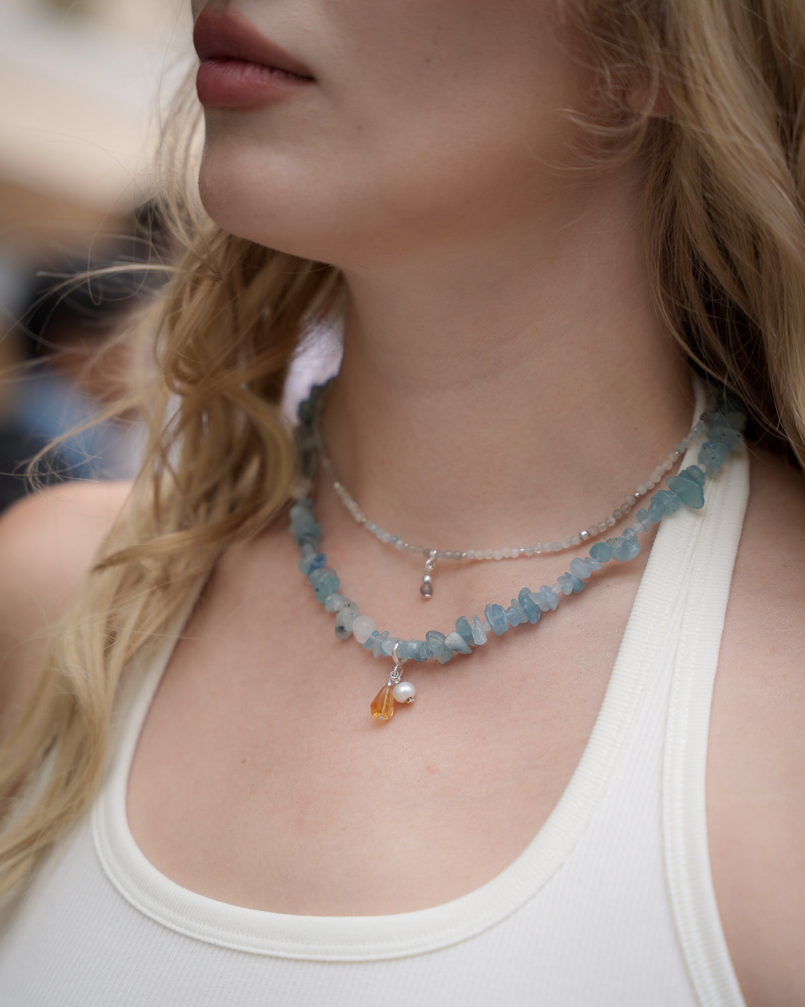 Aquamarine necklace with pearl and citrine charm, worn with a white tank top – contemporary gemstone jewelry by elswre