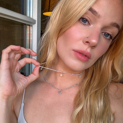 Model wearing the Hoi An Necklace with silver moon, star, and heart charms – handmade pearl necklace by elswre jewelry