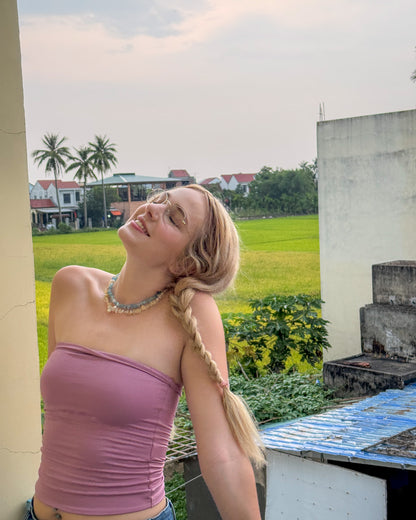 Model wearing citrine and silver necklace with pearl charm, styled with a soft pink top – luminous handmade jewelry from elswre